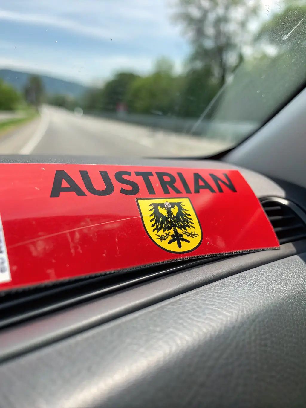 A close-up shot of a car smoothly passing through a highway toll booth in Austria, showcasing the ease of using a vignette.